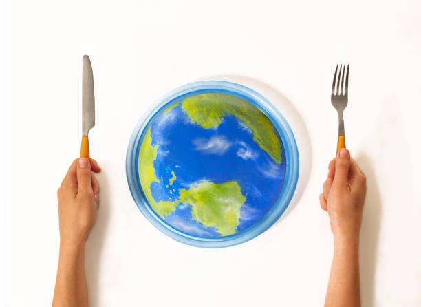 Eat the world on dish Ready to eat the world on dish using fork concept. extinction rebellion photos stock pictures, royalty-free photos & images