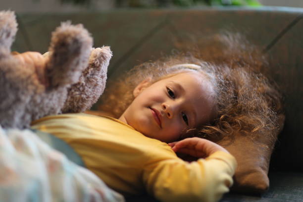 istock Young Girl Relaxing In sofa With Toy 1225272675