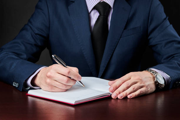 istock business plan and schedule concept. caucasian businessman write something at his diary book. 1225274212