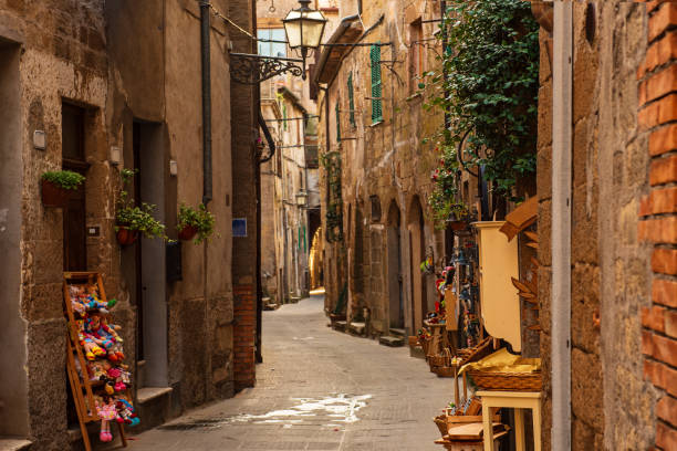 Pitigliano city street Narrow street of medieval ancient tuff city Pitigliano, travel Italy background pitigliano stock pictures, royalty-free photos & images