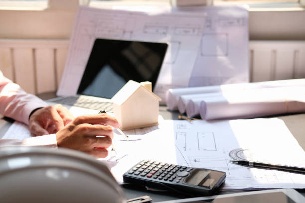 istock architect engineer working on house blueprint of real estate project at workplace. construction & building concept 1225276105