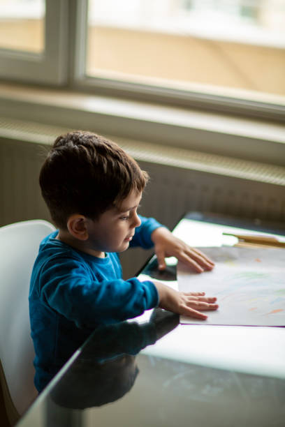 istock Adorable little boy, drawing picture 1225278197
