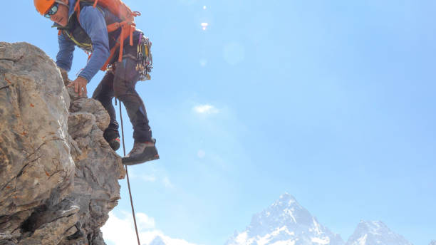 istock Mountaineer climbs up mountain face 1225278399