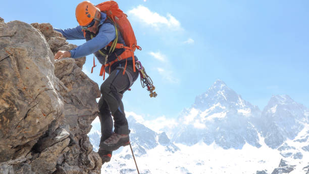 istock Mountaineer climbs up mountain face 1225278988