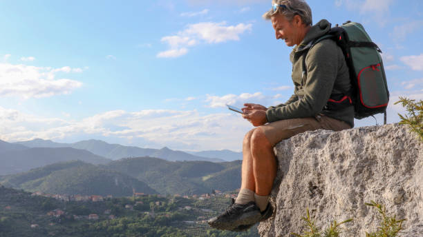 istock Hiker relaxes on mountain bluff in the morning 1225280774