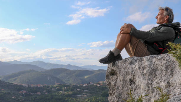 istock Hiker relaxes on mountain bluff in the morning 1225280793