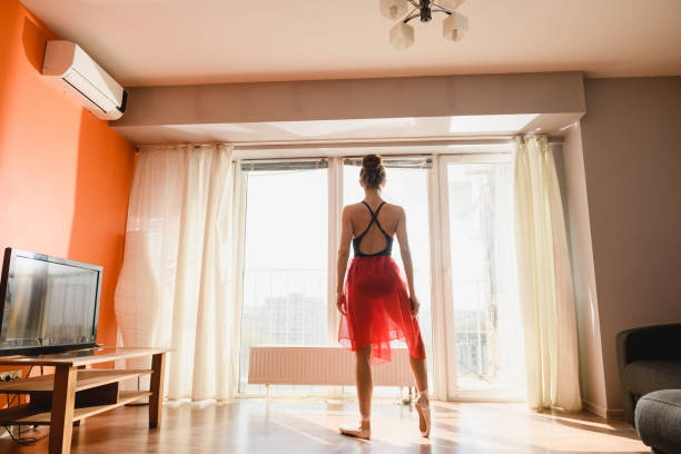 istock Ballet dancer stay back to window indoors 1225280833