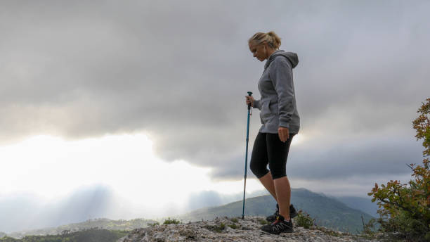 istock Female hiker relaxes on mountain ridge 1225280906