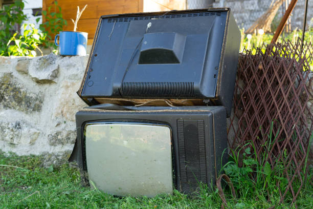 istock Discarded garbage Old TV set thrown by the wall and junk broken in day technology recycling electronic waste ready for recycle or to make a pollution two TVs 1225282766