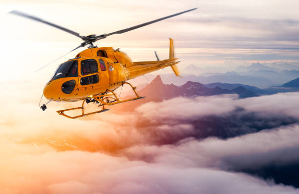 istock Yellow Helicopter flying over the Rocky Mountains 1225283701