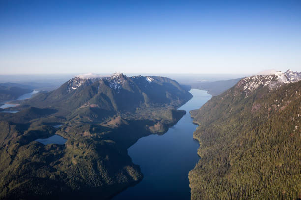 Aerial View of Remote Canadian Mountain Landscape Alouette Lake, near Vancouver, Fraser Valley, British Columbia, Canada. Beautiful Aerial View of Canadian Nature Landscape during a sunny spring morning. Background alouette lake stock pictures, royalty-free photos & images