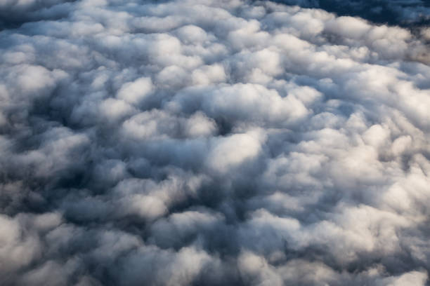 istock Aerial view from above a white and puffy clouds during a sunny sunrise. 1225284457
