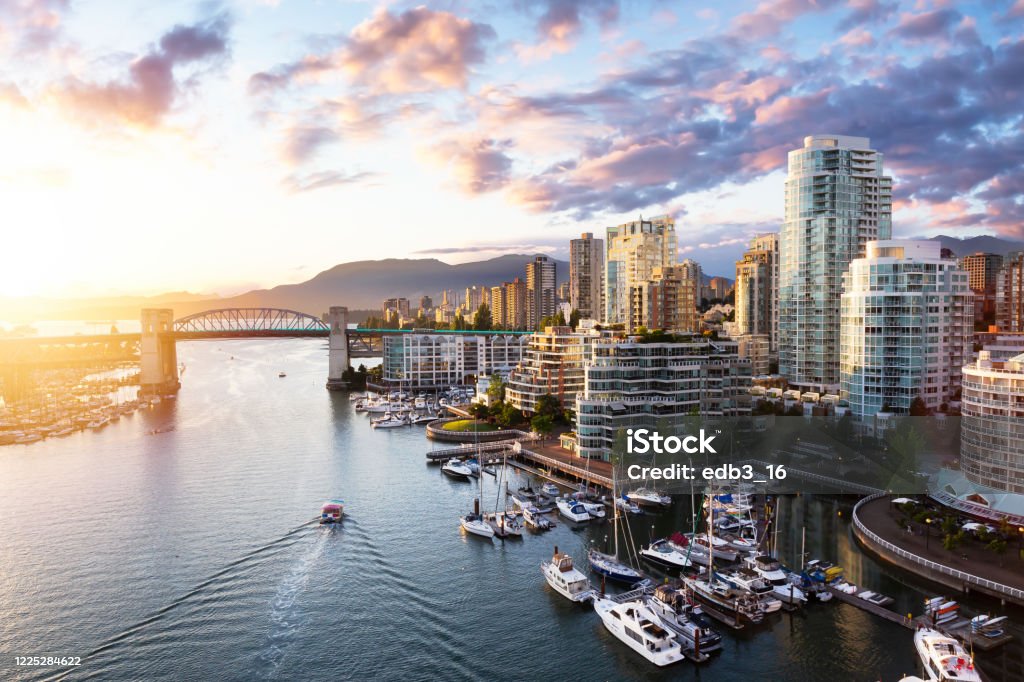 False Creek, Downtown Vancouver, British Columbia, Canada. False Creek, Downtown Vancouver, British Columbia, Canada. Beautiful Aerial View of a Modern City on the West Pacific Coast during a colorful Sunset. Sky Composite Vancouver - Canada Stock Photo