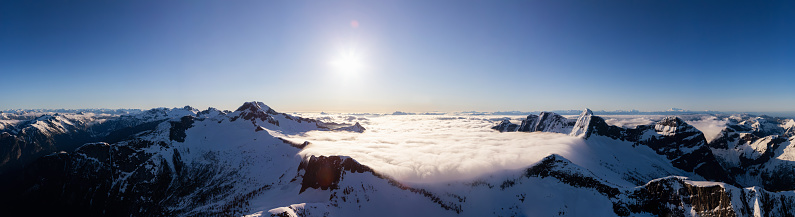 Aerial Panoramic View of the Rocky Canadian Mountain Landscape during a sunny morning Sunrise. Located near Vancouver, British Columbia, Canada. Nature Panorama Background