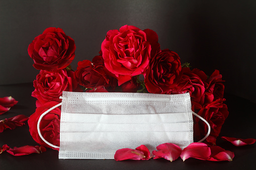 red roses and n95 mask on a black background