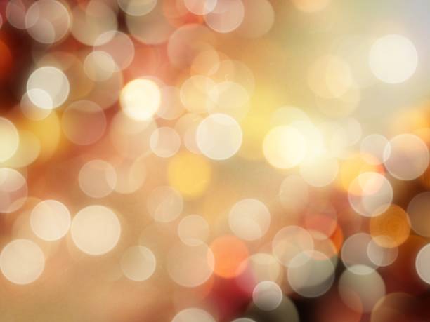 istock golden orange and white glowing round blurred lights with vibrant bright sparkle effect abstract background 1225285465