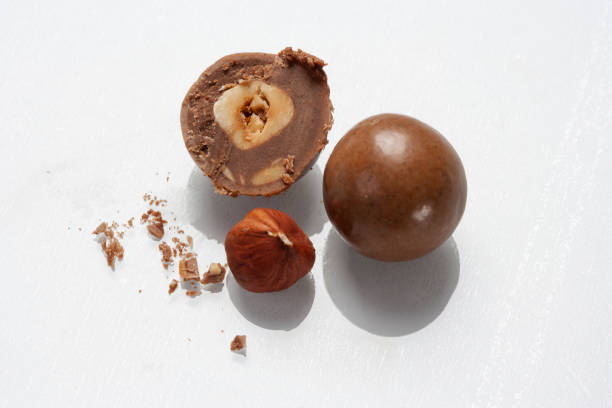 Chocolate candy ball filled with hazelnut stock photo