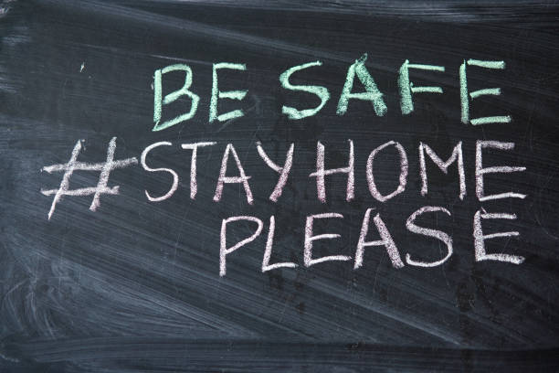 istock Hashtag stay at home. Outbreak Warning. written white chalk on blackboard in connection with epidemic of coronavirus worldwide. 1225290101