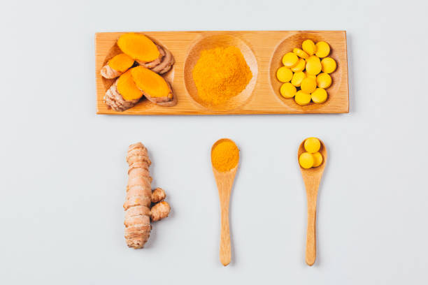 istock Turmeric in different conditions: dry root, tablets, powder and cut plant. 1225290401