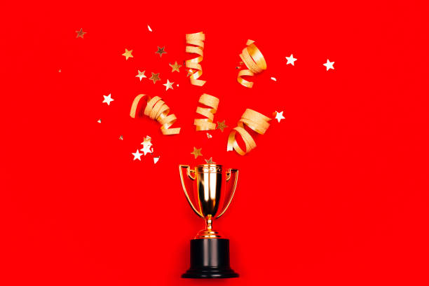 istock Golden winners cup with confetti 1225290405
