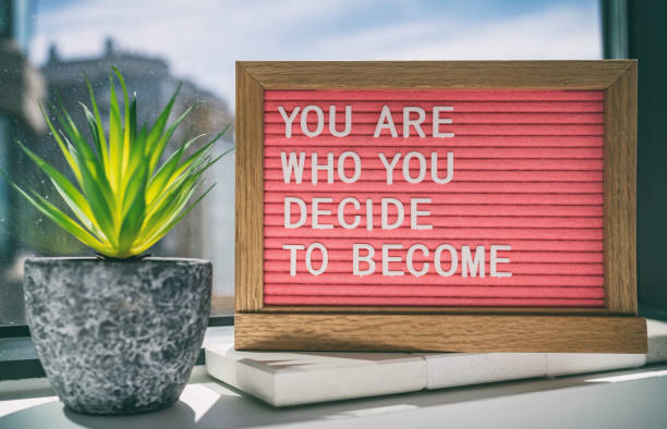 Inspiration quote message sign saying You are who you decide to become - life advice for self esteem, confidence. Home background Inspiration quote message sign saying You are who you decide to become - life advice for self esteem, confidence. Home background. motivation photos stock pictures, royalty-free photos & images