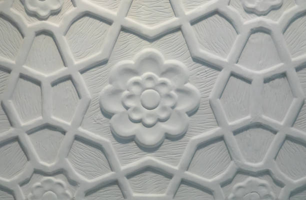 Indian style white flower symmetrical ornament on marble wall