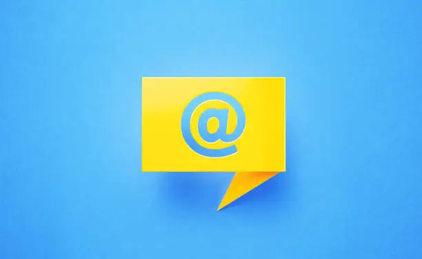 Photo of Yellow Chat Bubble with At Symbol on Blue Background