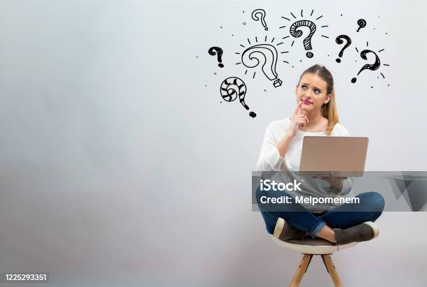 Question Marks With Young Woman Using Her Laptop Stock Photo - Download Image Now - Question Mark, Asking, Women
