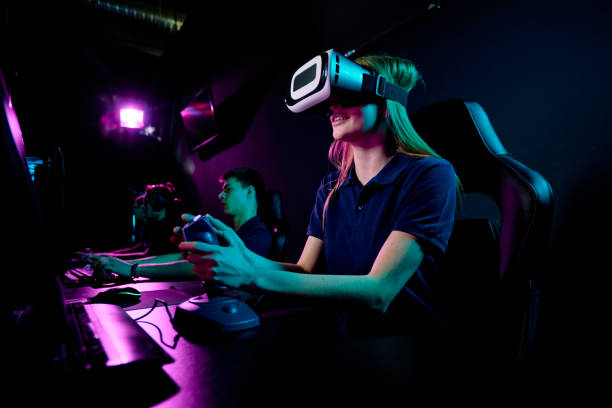 istock Contemporary eenage girl in vr headset using joystick during video game 1225294258