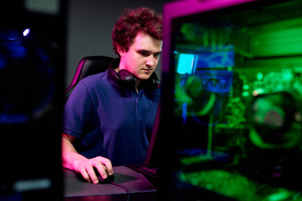 istock Serious guy with headphones looking at computer screen during e-sport cyber game 1225294262