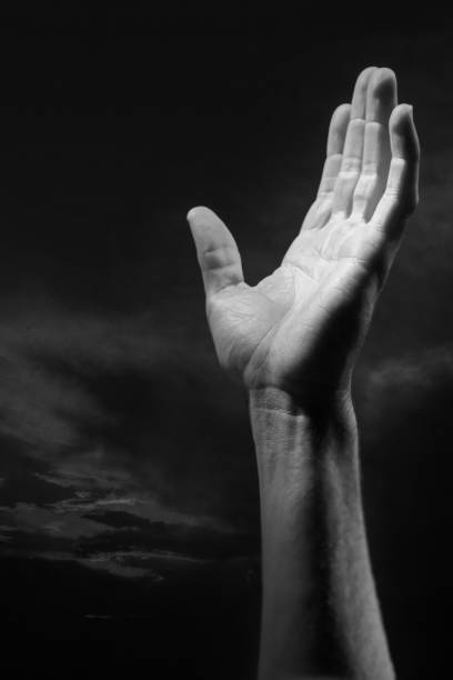 istock Black and white outstretched hand in the air 1225297695