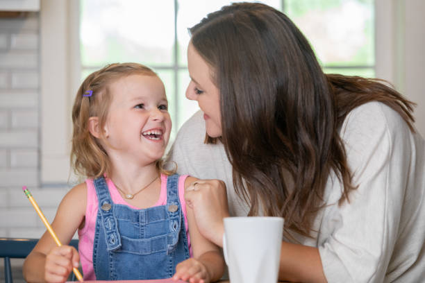 istock Little girl practices writing while spending time with her mom 1225299139