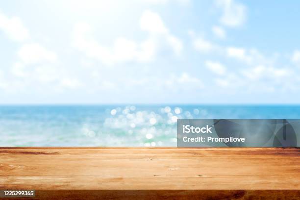 Wooden Table Top On Blurred Summer Blue Sea And Sky Background Copy Space For Your Display Or Montage Product Design Stock Photo - Download Image Now