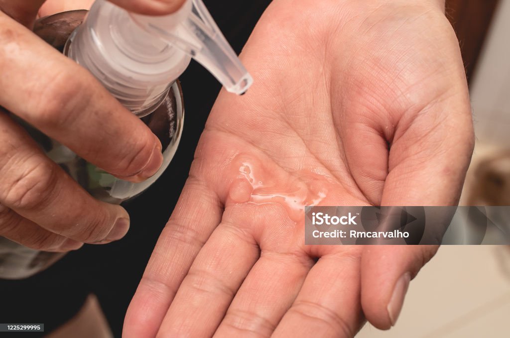 A woman holding a Hand sanitizer ( Álcool gel). Hand Stock Photo