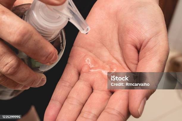A Woman Holding A Hand Sanitizer Stock Photo - Download Image Now - Hand, Adult, Adults Only