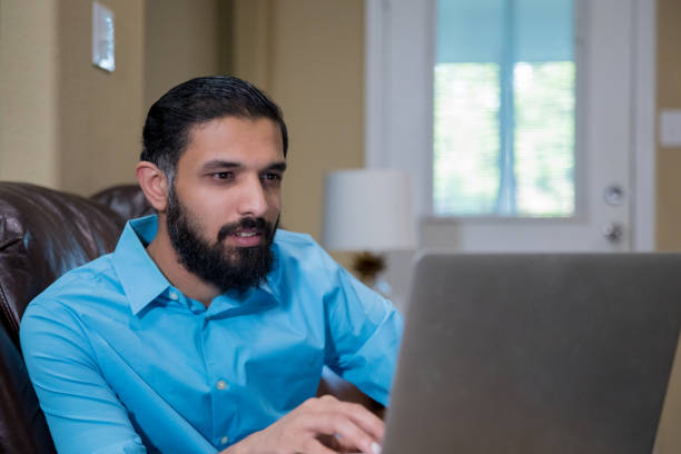 istock Businessman uses laptop to work remotely from home 1225303435
