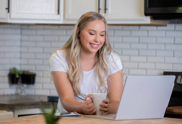 istock Happy woman is telecommuting while sitting at home in her kitchen 1225303488