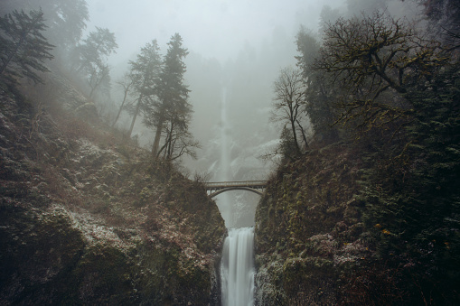 The world famous Pacific Northwest Waterfall Multnomah Falls during Ice Storm in Winter. Multnomah Falls is the tallest waterfall in the state of Oregon. It is credited by a sign at the site of the falls, and by the United States Forest Service, as the second tallest year-round waterfall in the United States