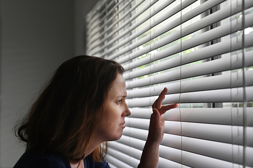 Adult woman suffering from Agoraphobia, fear of places and situations that might cause panic, helplessness or embarrassment. A progressive phobia may eventually lead to a fear of leaving the house