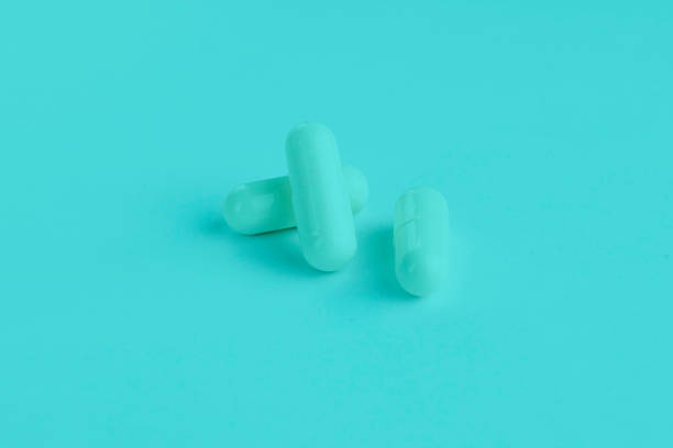istock Tree pills macro. Oval long shape remedies. Blue tone. Background or texture about Medicine, Health, Vitamins which support human body, hepl to immune viruses, infections 1225312781
