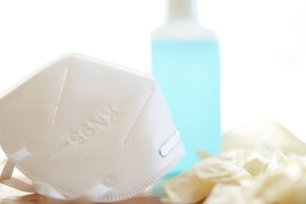 istock Respiratory mask disinfectant bottle and disposable gloves 1225318036