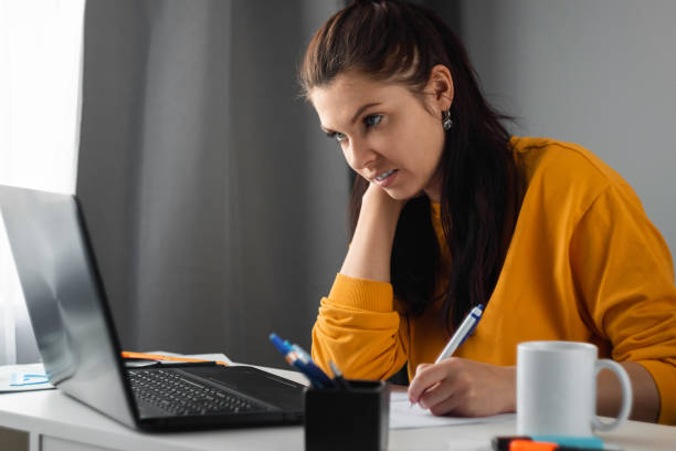 istock Beautiful girl using laptop working at home, concept of online work, remote work. Watching a webinar, looking for friends on social networks. Modern technologies. 1225323505