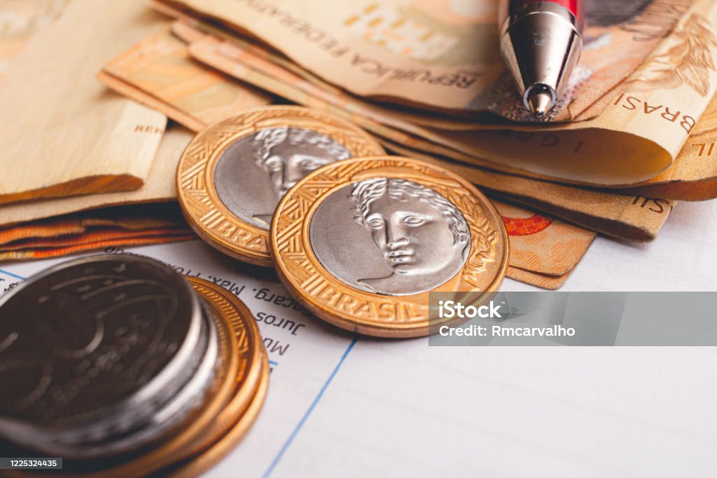 Real - Brazilian Currency. Money, Brazil, Reais. Real - Brazilian Currency. Money from Brazil. Real coins and Real banknotes on a white paper. Inflation - Economics Stock Photo