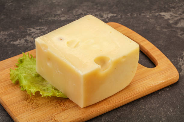 istock Emmental cheese over wooden board 1225324752