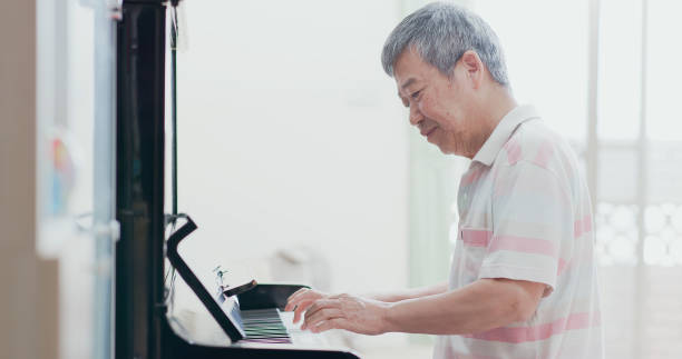 istock old man play the piano 1225328395