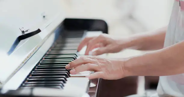 Photo of old man play the piano