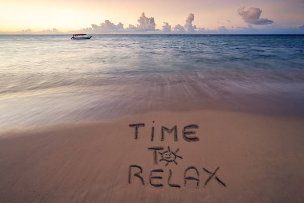 istock Handwritten Time to relax on sandy beach at sunset 1225329586