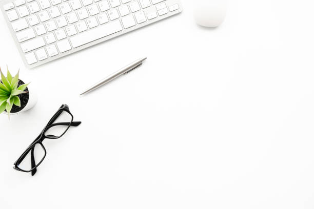 istock White minimal office desk table with computer keyboard with mouse and supplies. Top view with copy space, flat lay. 1225329872