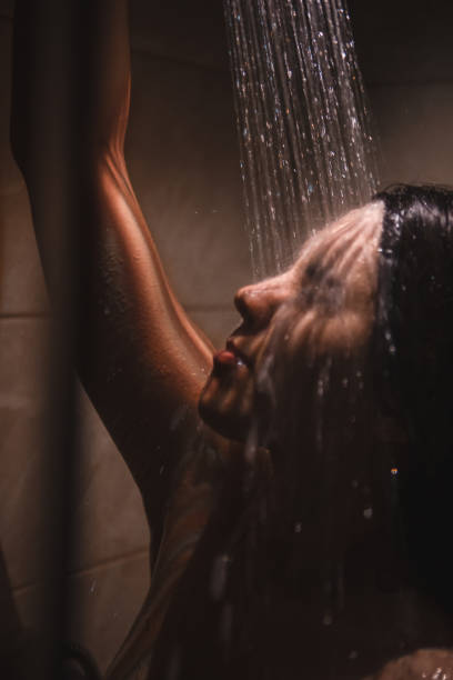 istock young pretty woman taking shower 1225329944