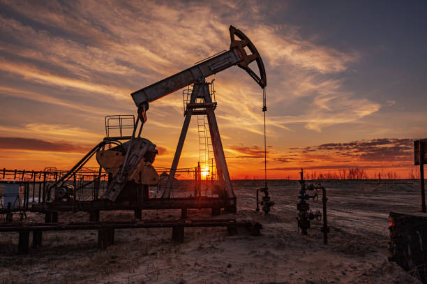 oil pump rig. oil and gas production. oilfield site. pump jack are running. drilling derricks for fossil fuels output and crude oil production. war on oil prices. global coronavirus covid 19 crisis. - fuel pump gasoline fossil fuel natural gas imagens e fotografias de stock